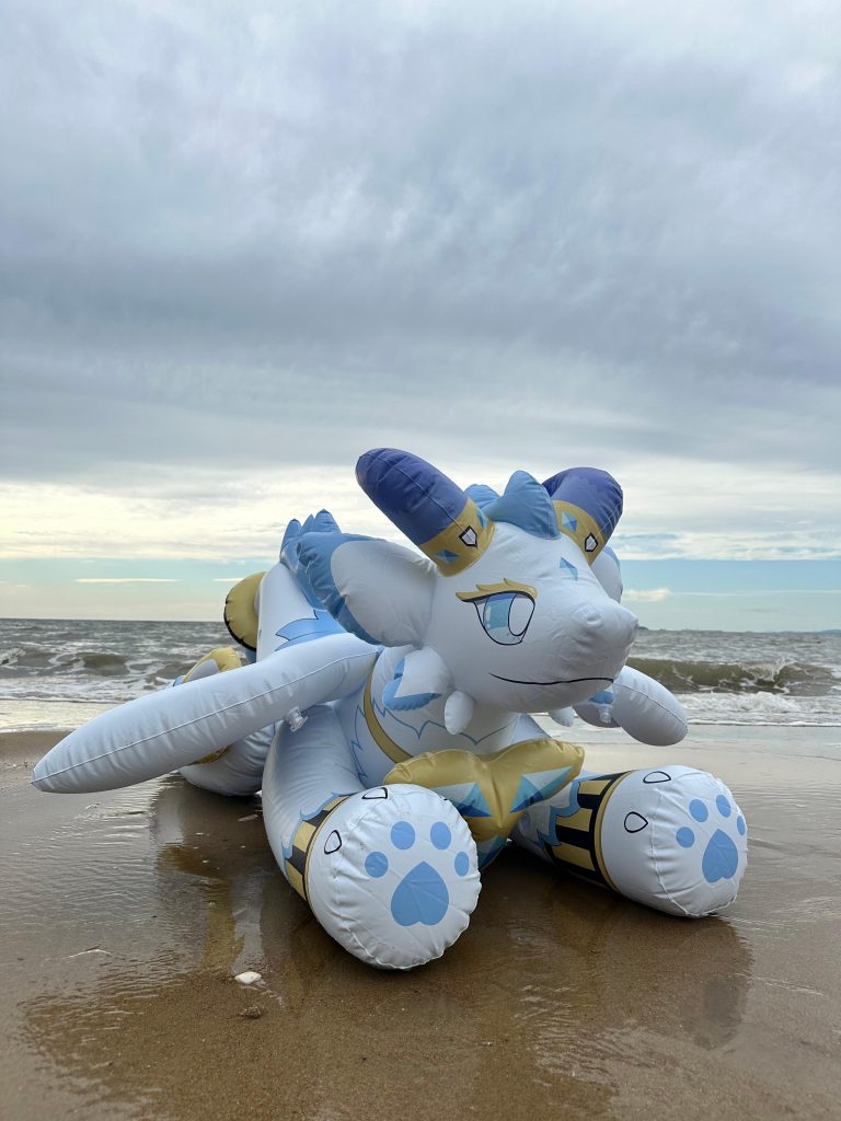 Blue and white inflatable character on the beach